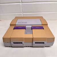 Front view of Super Nintendo console showing yellowed casing and controller ports