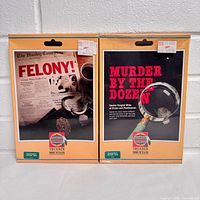 Front view of both sealed boxes: Felony! and Murder By The Dozen