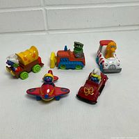 Group shot of five die-cast character vehicles