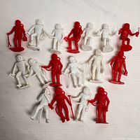 All sixteen red and white MPC astronaut figures laid out