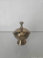 Front view of brass incense burner with lid attached