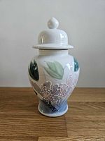 Front view of porcelain ginger jar with lid showing floral design