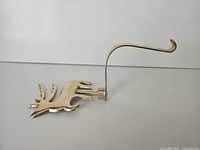 Side profile showing reindeer figure and hook mechanism