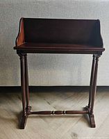 Front view of book table showing open shelf and leg design