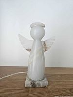 Front view of onyx angel night light, unlit, showing overall shape and cord