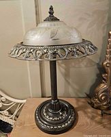 Full front view showing glass shade, metal base and column