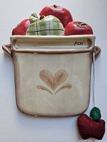Front view of ceramic crock dry erase board with apple motif and attached felt apple eraser