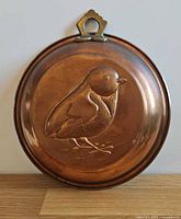 Front view of copper bird mold showing full design and loop