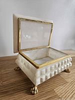 Box open, showing alabaster interior, brass frame, claw feet