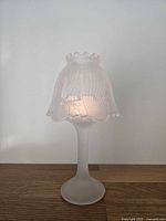 Lamp assembled and lit to show frosted and clear glass details