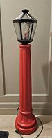 Full view of red blow mold lamp post unlit