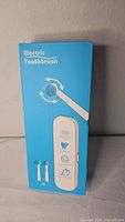 Front of blue box labeled Electric Toothbrush