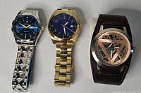 All three watches side by side showing fronts and bands