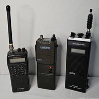 Front view of all three handheld radios with antennas visible