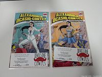 Both signed comics in protective sleeves with COAs visible