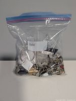 Ziploc bag containing all paired vintage earrings