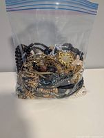 Bagged lot showing assorted necklaces in various materials and colors