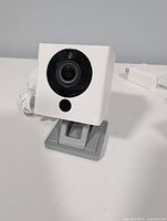 Single Wyze Cam v2 on gray base with attached USB cable