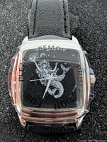 Front view of watch showing mermaid dial and protective film
