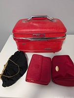 Exterior view of red M&W train case with three smaller bags