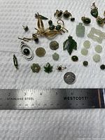 overview of assorted jade items with ruler for scale