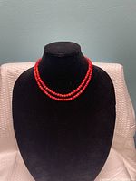 Necklace displayed on bust showing double strands and bead size