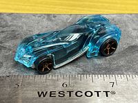 Left side view of translucent blue Hot Wheels car with ruler for scale