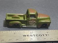 Left side view of green/rust Hot Wheels ’52 Chevy showing Mighty Max Garage tampo