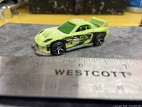 Side view of lime green Hot Wheels 24/Seven showing number 37 graphics