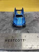 Front view showing hood graphics and approximate length with ruler