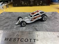 Top and side view of Hot Wheels Surf Crate car beside ruler