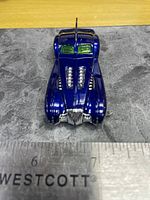 Top view of metallic blue Screamliner showing twin hood intakes and grille with ruler for scale