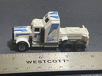 Left side profile showing cab, sleeper and decals with ruler for scale