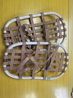 Both snowshoes stacked showing frame and leather lattice