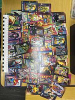 Overview of spread of Marvel trading cards with ruler for scale