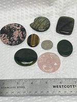 Group view of all seven cabochons with quarter and ruler