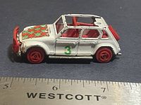 Left side profile showing body colour, wheels, hood decal and number