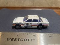 Right side profile showing decals and overall wear with ruler for scale