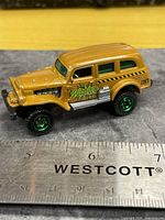 Left side view of Jungle Crawler showing graphics and wheels with scale ruler