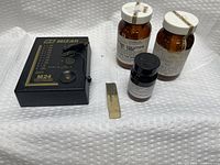 Main tester unit, three solution bottles, touchstone on white background