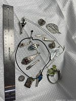 Overhead view of entire jewellery lot beside ruler for scale