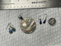 Group shot showing pendant, two earring pairs, ruler and dime for scale