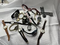 Group of mixed Timex wristwatches and parts on white background