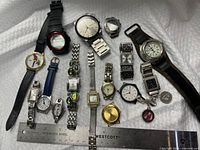 Group shot of all watches, parts and coin for scale