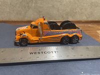 left side view of truck beside ruler