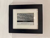 Front view of black Umbra Harmony frame showing white mat and size information