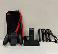 Dock, grip, carry case, five wrist straps shown together