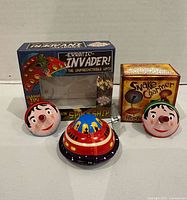 Group shot of all tin toys with packaging