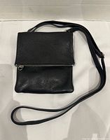 Front view showing flap closed and strap