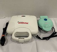 Toastmaster Snackster sandwich maker and mint green mini waffle maker with cords